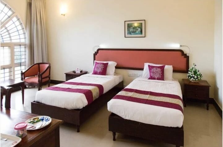 Family twin room with maroon bed runners at ATS Willingdon Hotel